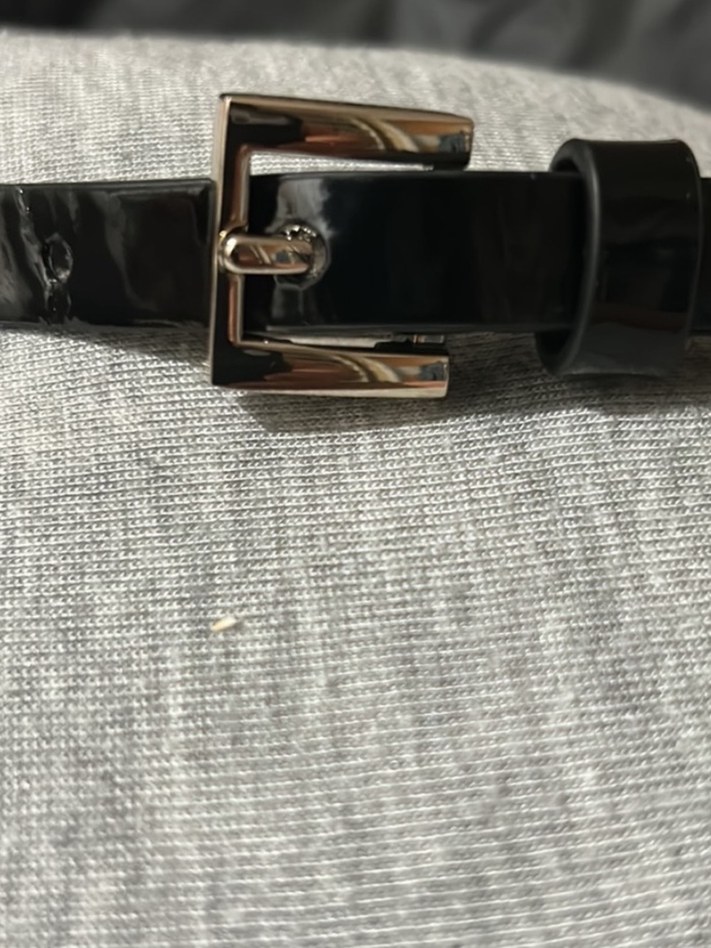 Black patent leather belt.